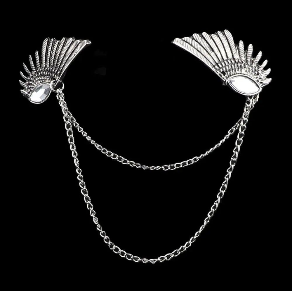 Anel Demosthene Dragon lapel pin with retro tassel chain, worn on a suit collar for a stylish, vintage accessory look.