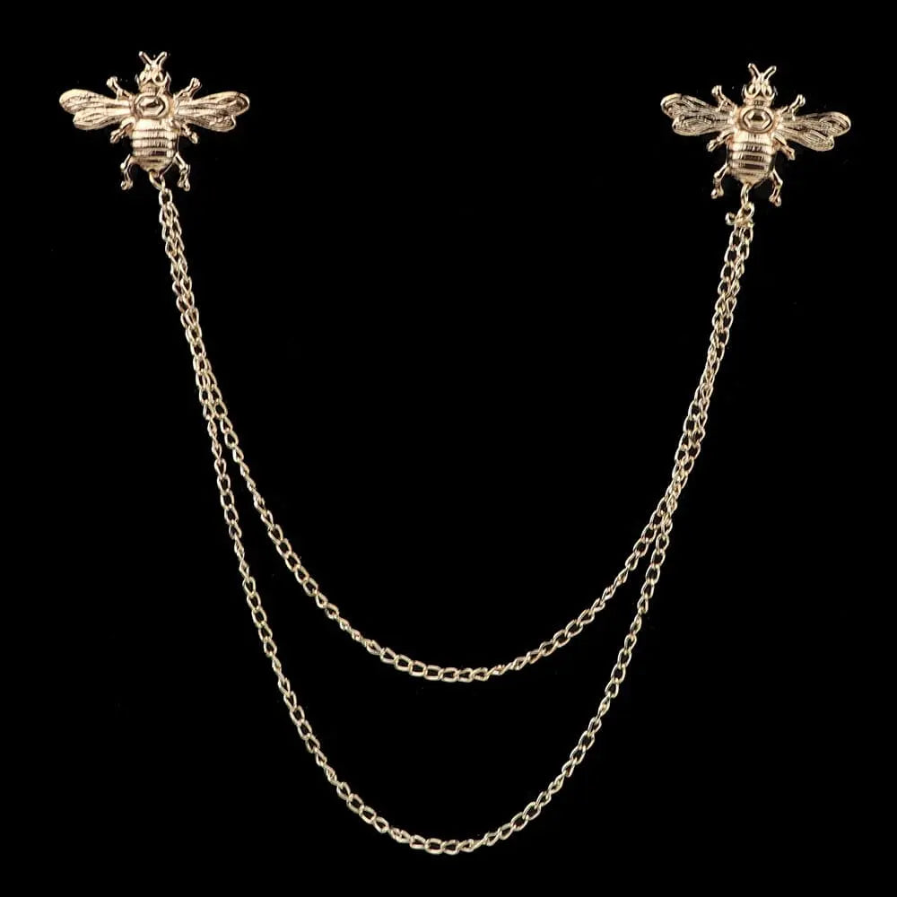 Anel Demosthene Dragon Lapel Pin on a man's suit collar, featuring a retro tassel chain and dragon badge accessory.