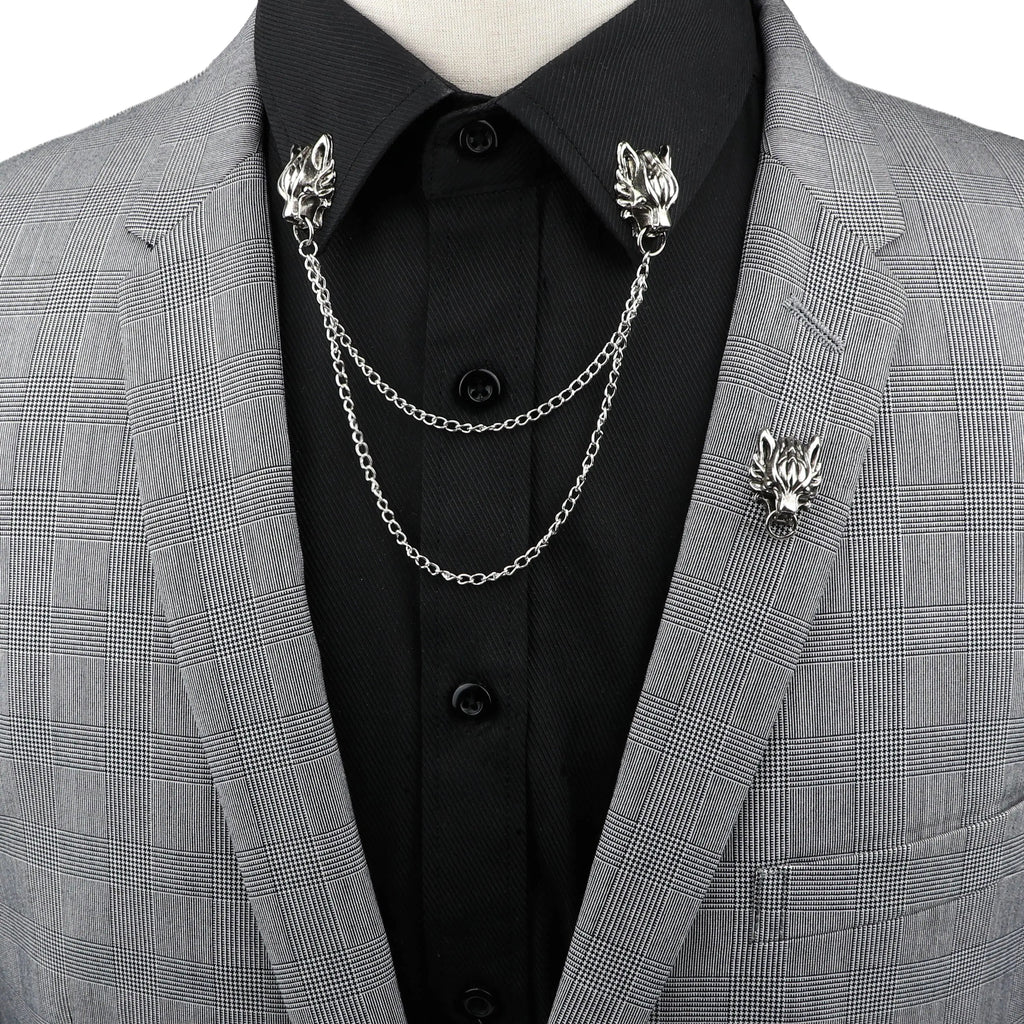 Anel Demosthene Dragon lapel pin with retro tassel chain, worn on a suit collar for a stylish men's accessory.