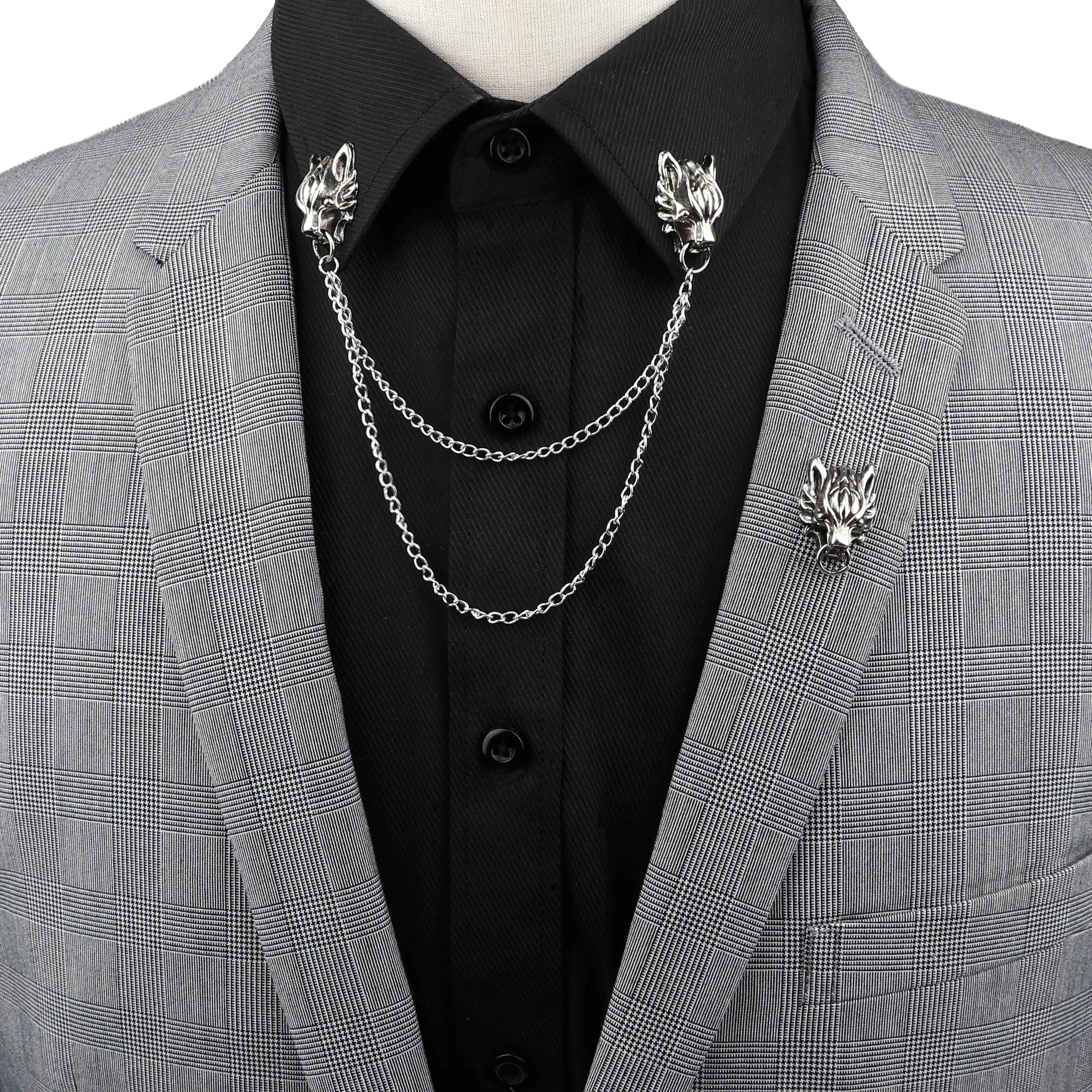 Anel Demosthene Dragon lapel pin with retro tassel chain, worn on a suit collar for a stylish men's accessory.