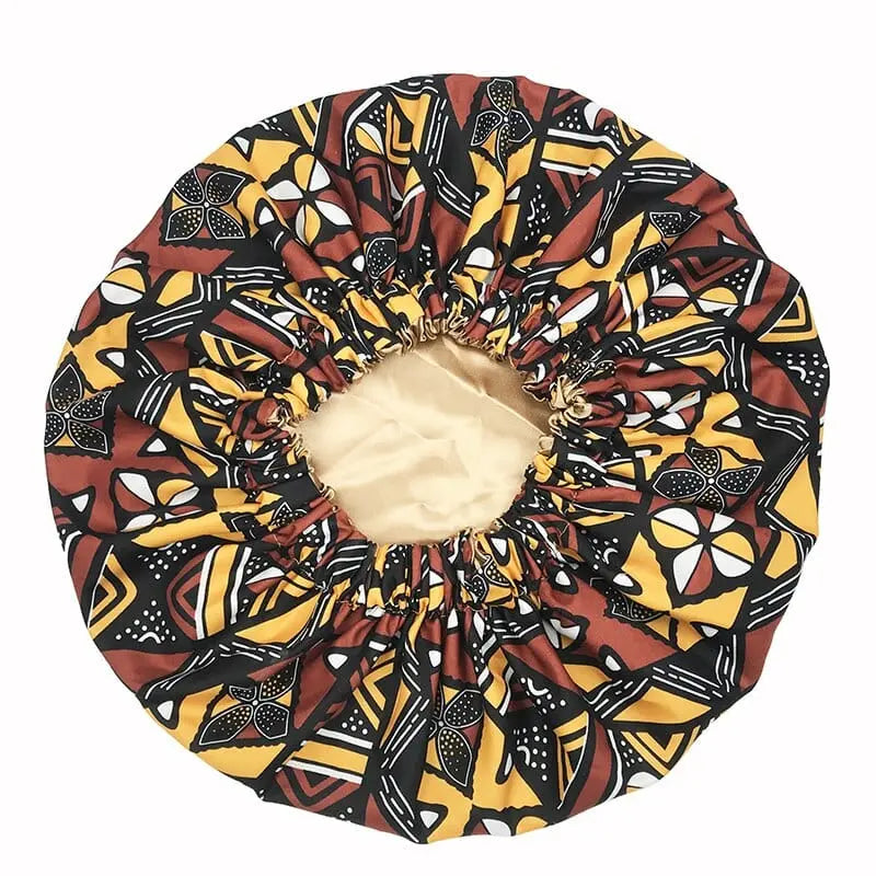 African Ankara satin-lined bonnet with long ribbon headwrap, showing vibrant Ankara pattern and double-layer design for women.
