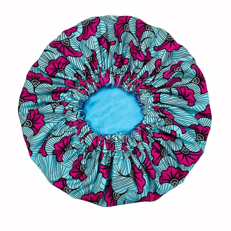 African Ankara satin-lined bonnet with long ribbons and headwrap design, featuring vibrant traditional patterns for women.
