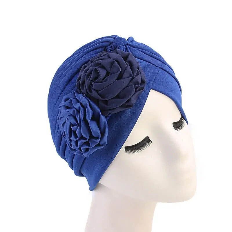 Solid color flower-decorated turban for women, stylish head wrap and hair accessory, ideal for fashion or special occasions.
