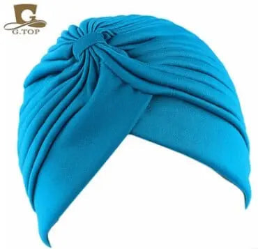 Stretchy women's turban cap with twisted pleated design in assorted colors, ideal as chemo headwear or stylish hair cover.