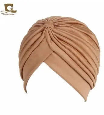 Stretchy women's turban cap with twisted pleats, chemo beanie hat in assorted colors, designed for comfortable head coverage.