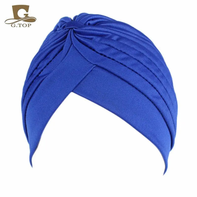 Stretchy women’s twisted pleated turban cap in assorted colors, made by Showlu Fashion, designed as a comfortable chemo head cover.