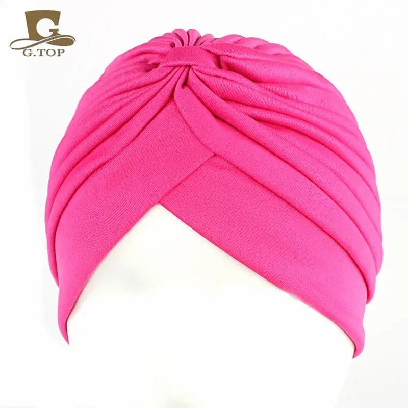 Stretchy women's turban cap with twisted pleats, chemo beanie hat in assorted colors, designed for comfort and style