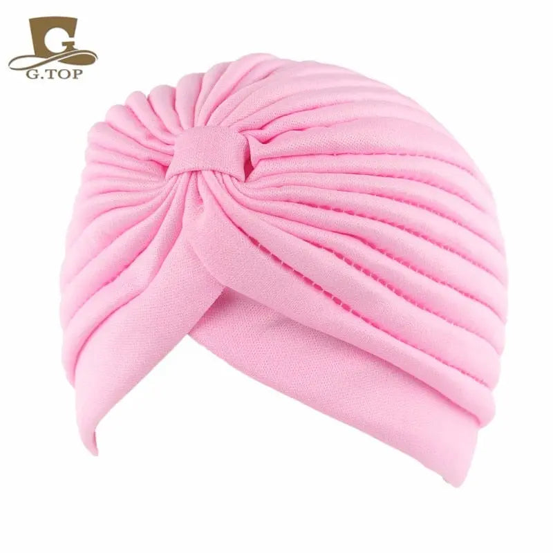 Stretchy women's turban cap with twisted pleated design, in assorted colors, perfect as chemo headwear or stylish hair cover.