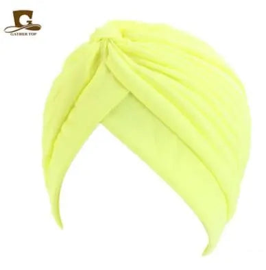 Stretchy women's turban cap with twisted pleated design, available in assorted colors, ideal as a chemo head wrap or fashionable beanie.