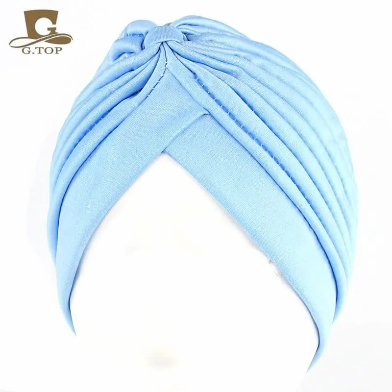 Stretchy women's turban cap with twisted pleats, chemo head wrap, in assorted colors, designed for hair coverage and style.