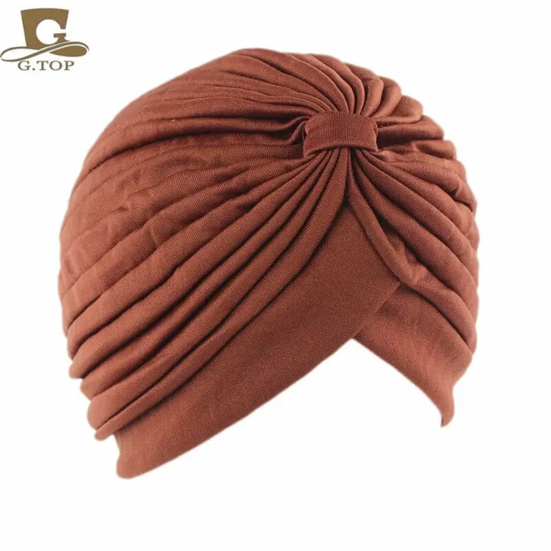 Women’s stretchy turban cap with twisted pleats, chemo beanie style, in assorted colors, suitable for hair coverage and stylish wear.