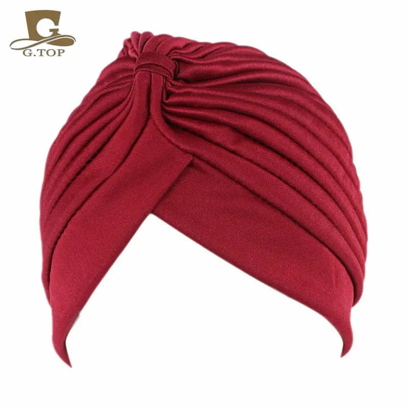 Showlu Fashion stretchy women's turban cap with twisted pleated design, in assorted colors, ideal as a chemo beanie or head wrap.