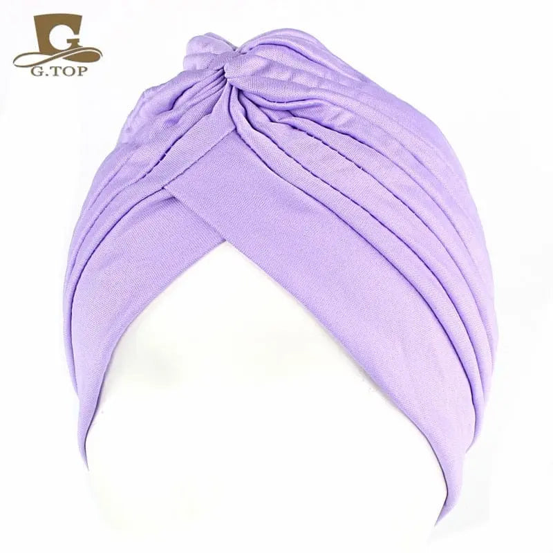 Stretchy women's turban cap with twisted pleats, chemo beanie hat in assorted colors, perfect for hair coverage and fashion.