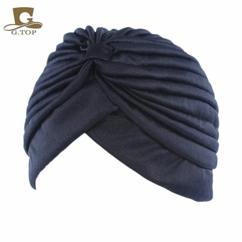 Stretchy women's turban cap with twisted pleats, chemo beanie hat in assorted colors, ideal for hair coverage and stylish comfort.
