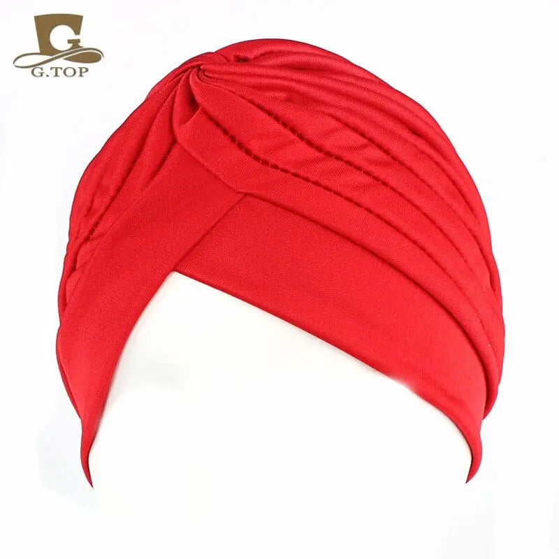 Stretchy women's turban cap with twisted pleats in assorted colors, designed as a chemo beanie hat for women and girls.