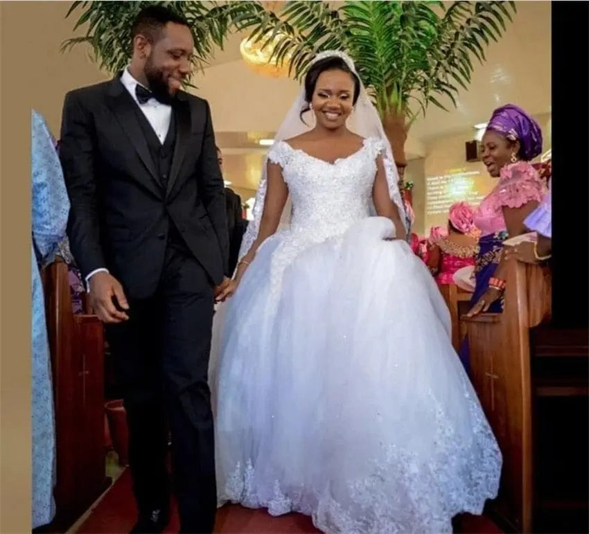 White NUO XI FANG V-neck ball gown wedding dress with beaded lace appliques, sleeveless design, court train, plus size available.