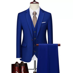 A slim-fit royal blue three-piece suit with a white shirt, patterned tie, and brown dress shoes.