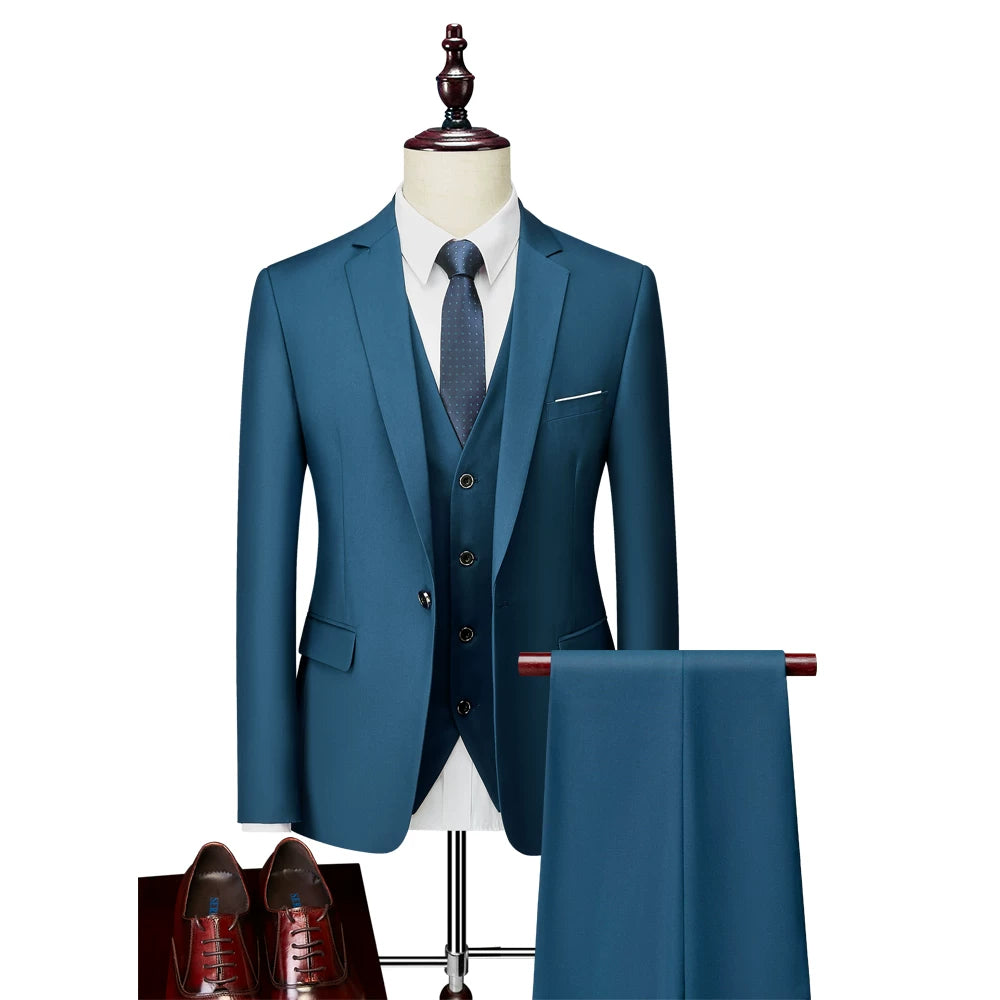 A slim-fit teal blue three-piece suit with a single-breasted jacket, vest, and matching trousers.