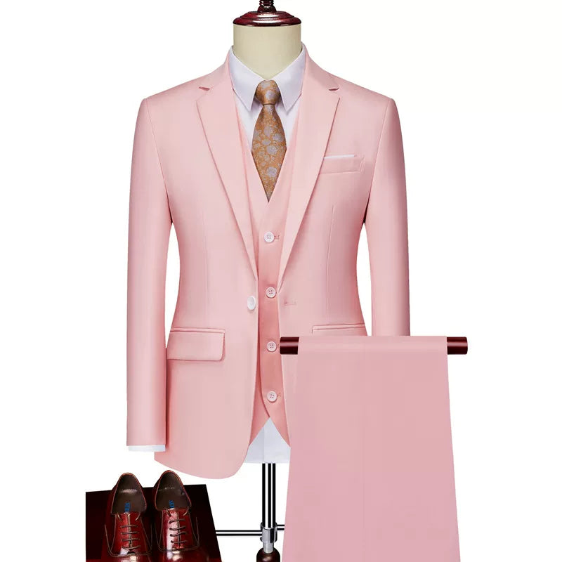 A slim-fit light pink three-piece suit with a white shirt and brown patterned tie.