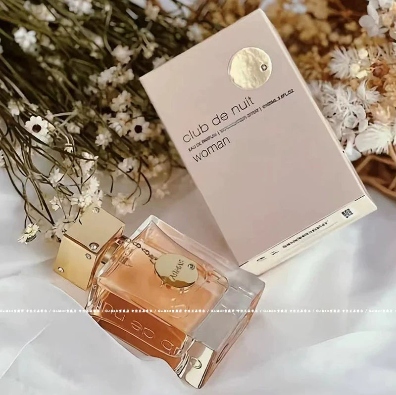 Fruity floral perfume sample for women, Armaf Club de Nuit Woman EDP, showcasing an elegant bottle with colorful floral accents.