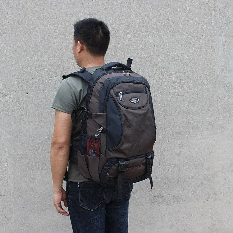 Large 70L waterproof hiking backpack with multiple compartments, wear-resistant material, suitable for trekking, camping, and travel.