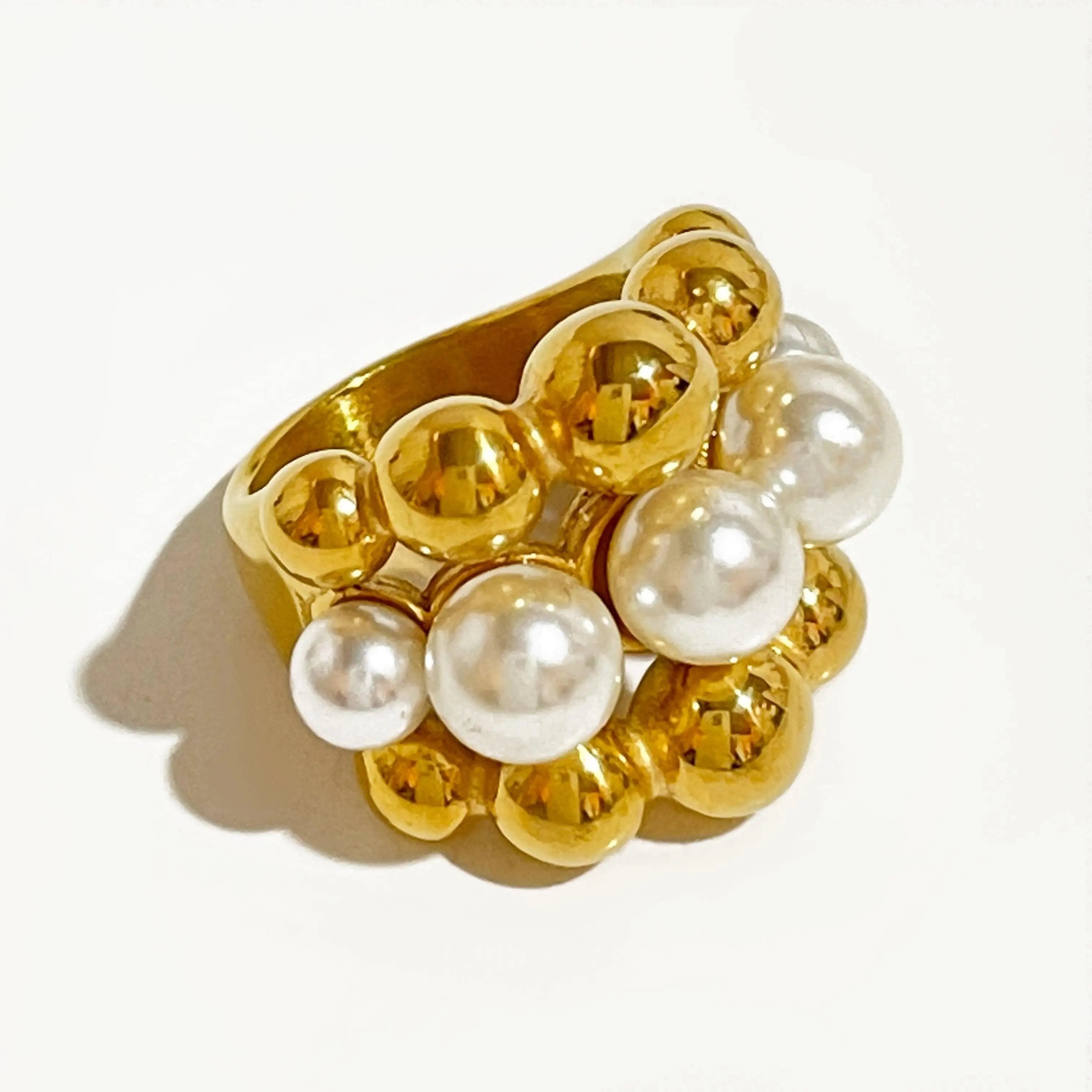 Gold plated stainless steel statement ring with chunky faux pearls and bold design, perfect for modern women.