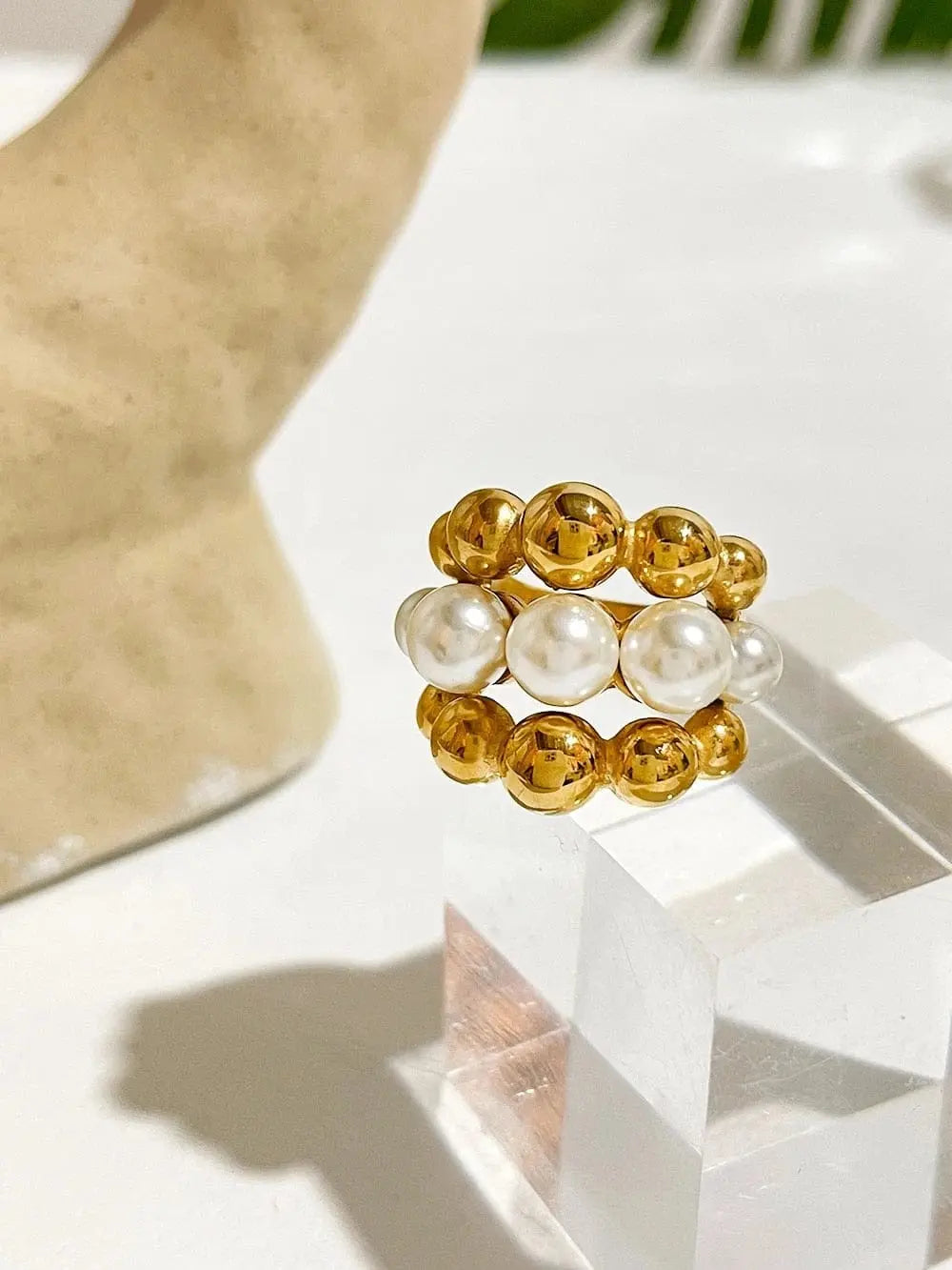 Gold plated stainless steel statement ring with chunky faux pearls, large design, perfect for bold fashion looks.