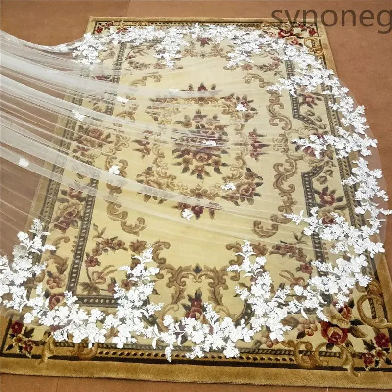 White lace-edged one-layer cathedral wedding veil with comb, ivory appliqué, perfect for bridal wedding attire.