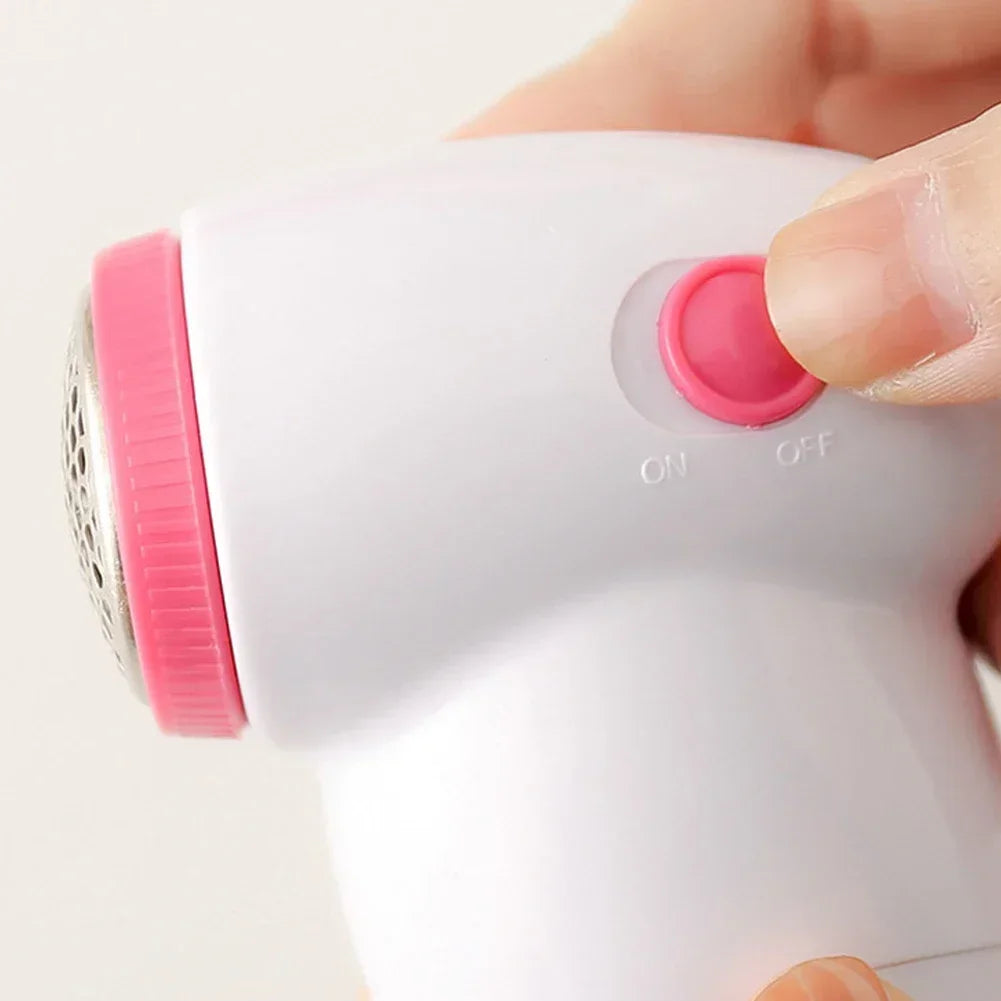 Electric lint remover fabric shaver by Showlu Smart General with a handheld design and stainless steel blade for removing lint and fuzz.