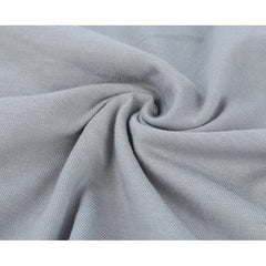 Close-up view of soft, light gray knitted cotton fabric with gentle folds.