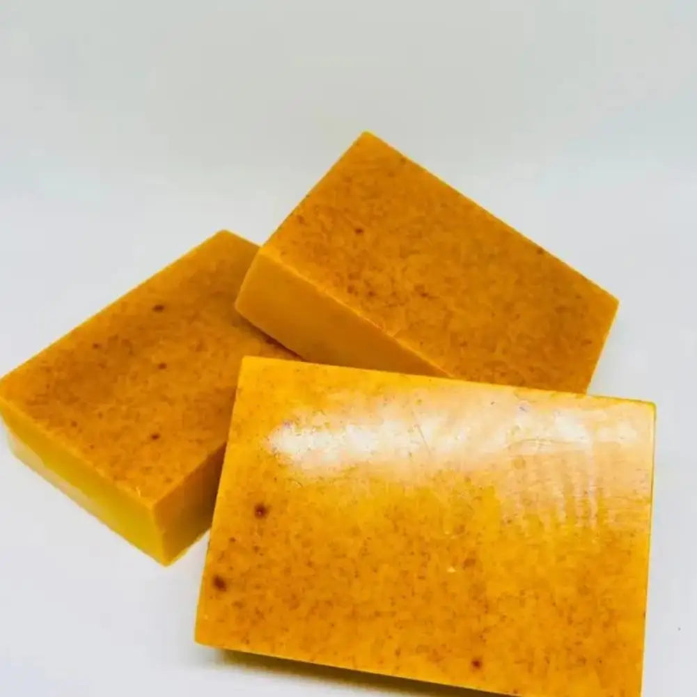 Handmade turmeric soap with lemon and kojic acid, natural body and facial shower soap, displayed in a neat stack.