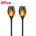 Solar Dancing Flame LED Garden Lantern by Showlu Smart General, showing a realistic flickering flame effect in a garden setting.