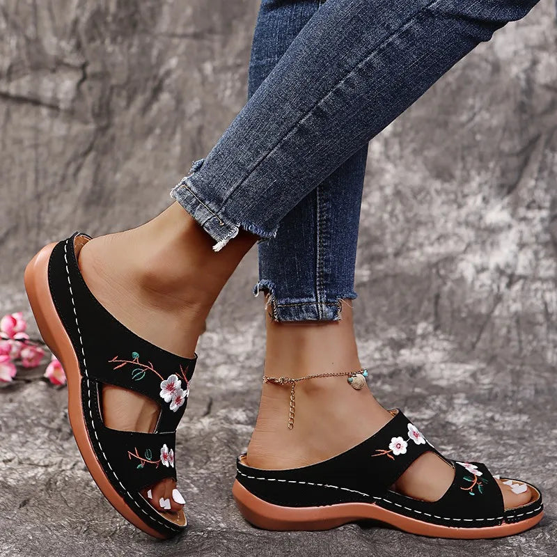 SHOWLU Women's embroidered flower leather wedge sandals with summer slip-on design, featuring colorful floral embroidery and comfortable sole.