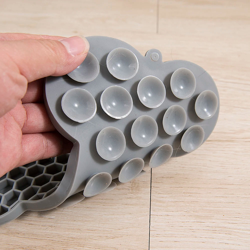 Silicone dog licking pad with bone design from Showlu Fashion Store, used as a feeding mat for dogs and cats.