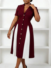 A burgundy knee-length dress with a notched collar, short sleeves, and white pleated side panels.