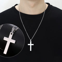 A person wears a simple silver stainless steel cross pendant on a matching link chain.