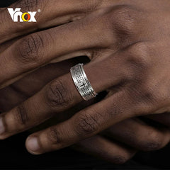 A silver stainless steel spinner ring for men engraved with the Lord's Prayer and a cross.