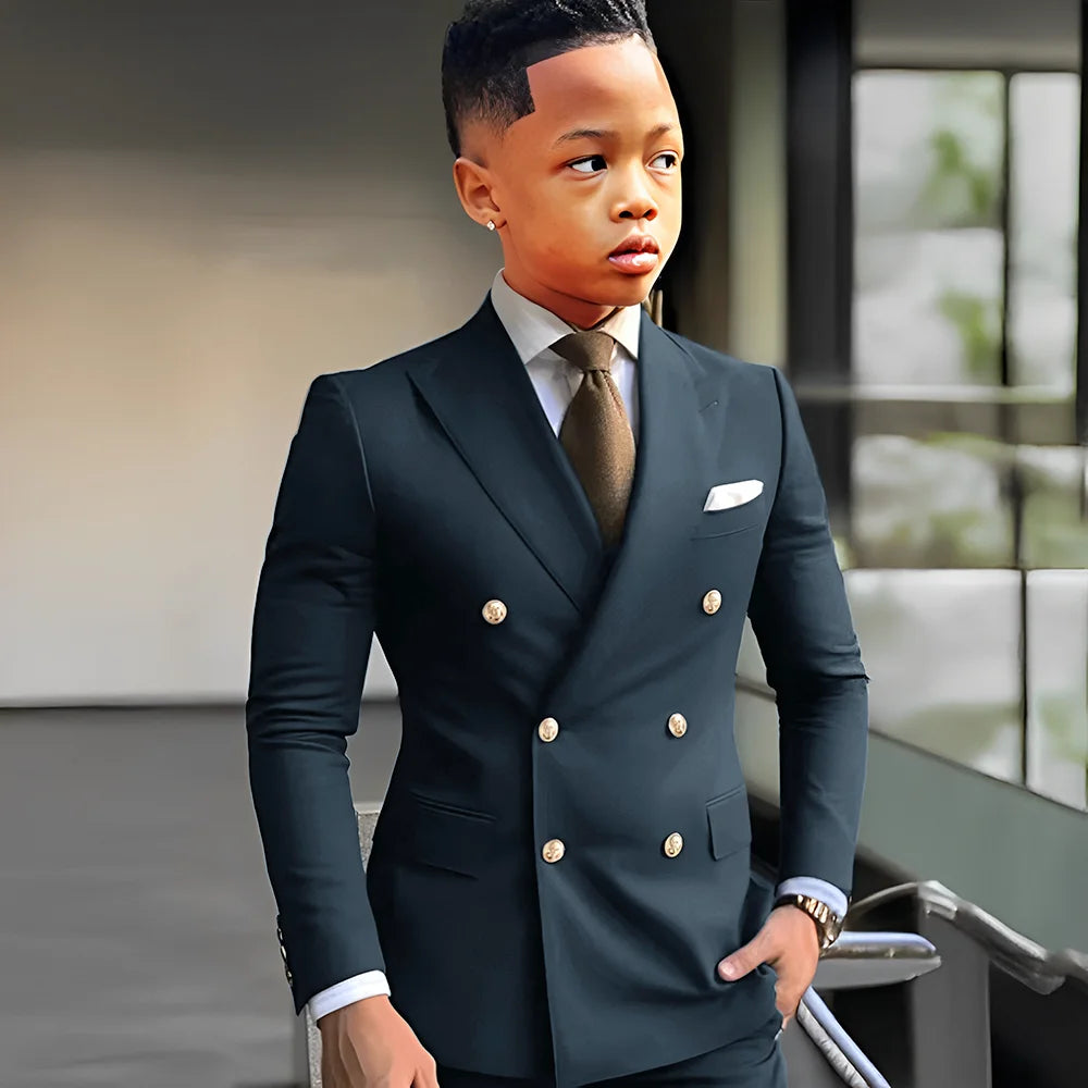 Elegant navy blue boys' tuxedo with peak lapel, double-breasted style, suitable for weddings and formal events, by Showlu Fashion.