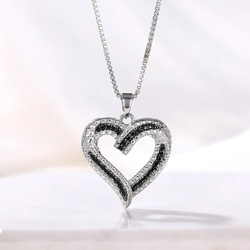 Heart-shaped pendant necklace by ZHIXUN featuring hollow zinc alloy design, ideal for party jewelry and stylish accessories.