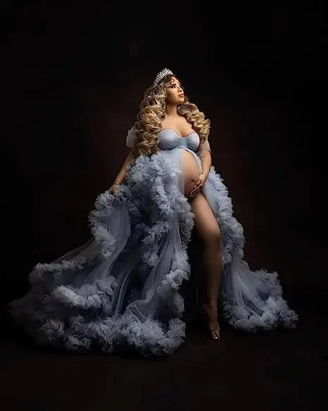 Elegant deep V-neck tulle maternity dress with lace hollow details, long sleeves, and feather accents, perfect for photoshoots.