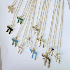 A collection of gold-tone Hebrew Chai pendant necklaces featuring various colors and textures.