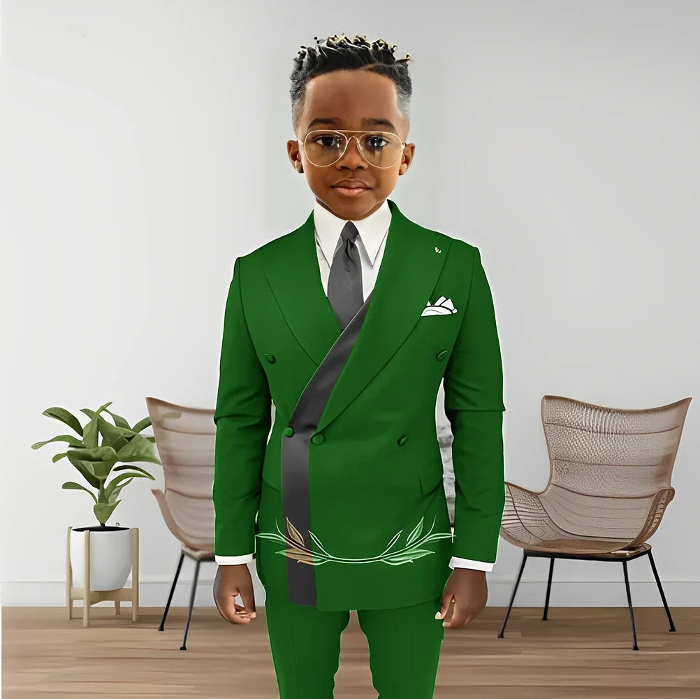 Boy wearing a double-breasted blazer and pants from Showlu Fashion's 2-piece boys' wedding tuxedo set, suitable for ages 2 to 16.