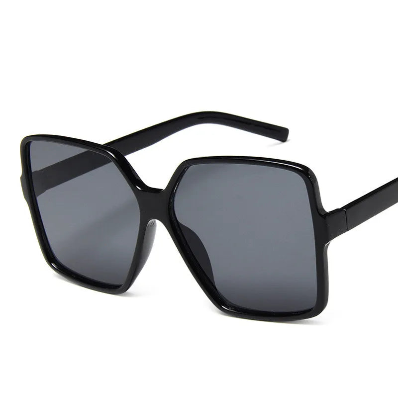 Oversize women's sunglasses with gradient lenses and UV400 protection, stylish plastic design by Showlu Fashion.