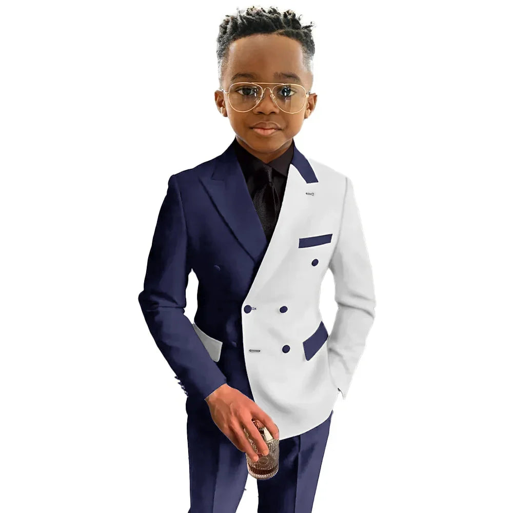 Boy in a white and royal blue double-breasted wedding suit by SZMANLIZI, featuring tailored fit and stylish details.