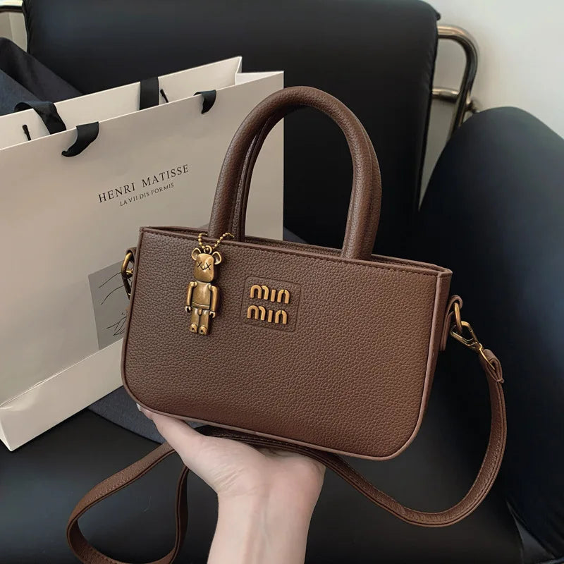 Minimalist luxury phone pouch and crossbody bag by 1170uf-he featuring sleek design and compact size in black.