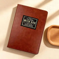 Brown 365-day prayer journal for men titled "One Minute With God," featuring daily prompts for spiritual reflection.