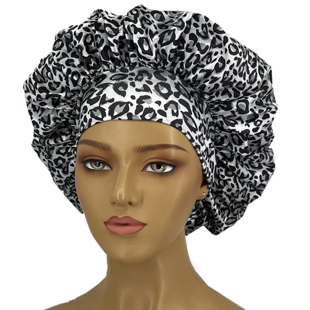 Leopard print women’s sleep bonnet by Showlu Fashion Store with wide elastic band, soft curl-enhancing sleep cap for dry and textured hair.