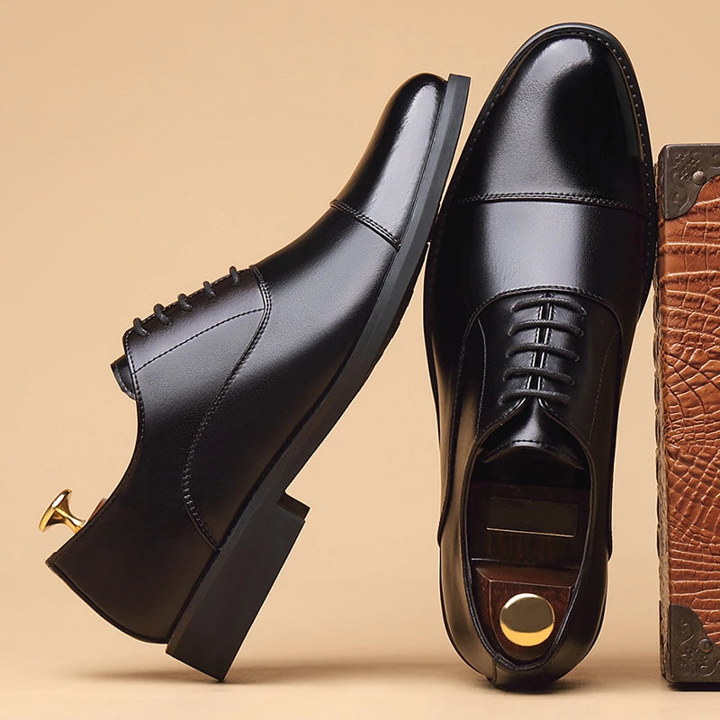 Men's black genuine leather dress shoes with cap toe, lace-up design, suitable for business, formal, and wedding occasions.