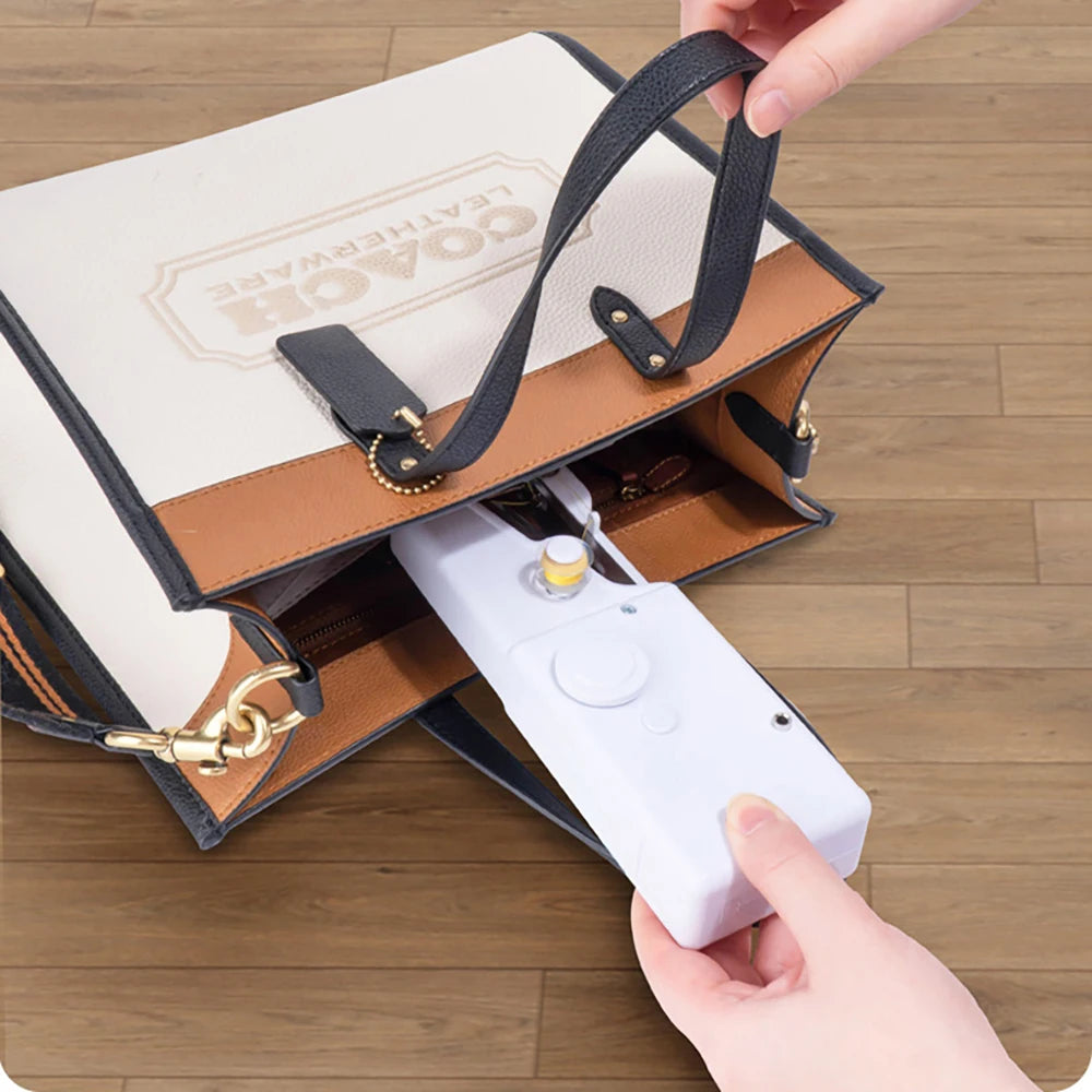 Showlu Smart General mini handheld sewing machine with compact design and sewing needle, ideal for quick repairs and small sewing projects.