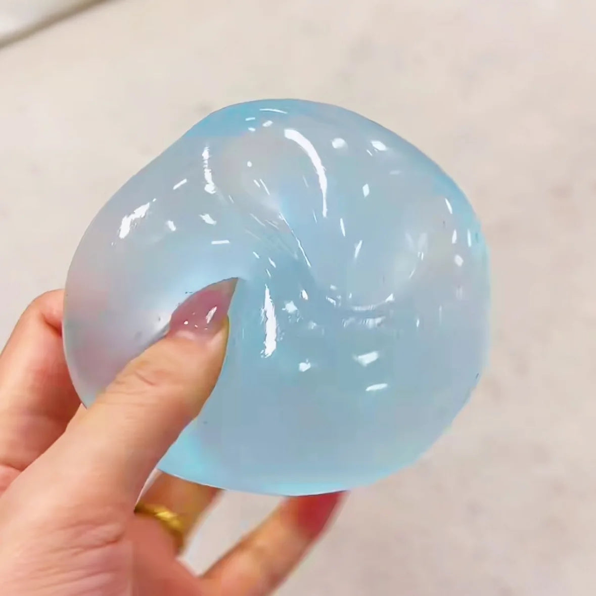 Transparent squishy maltose stress ball by Showlu Fashion Store, slow-rise sensory ball for hand exercise and stress relief.